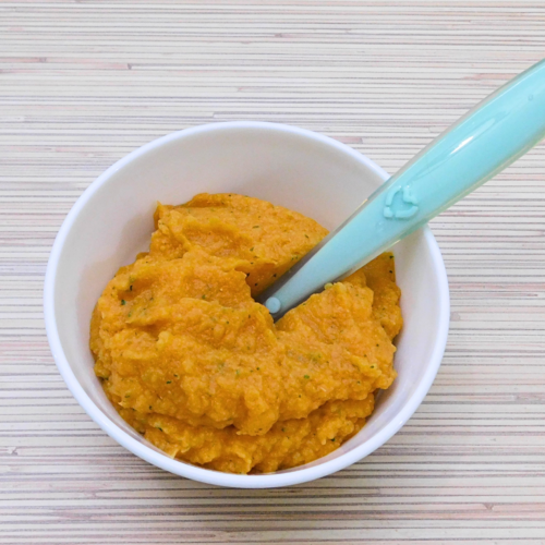 Sweet potato and chicken for baby with cauliflower and parsley in a white bowl